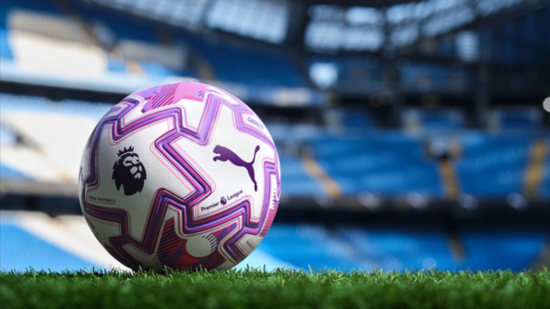 an image of the purple and white PUMA x Premier League match ball on the corner of a stadium pitch