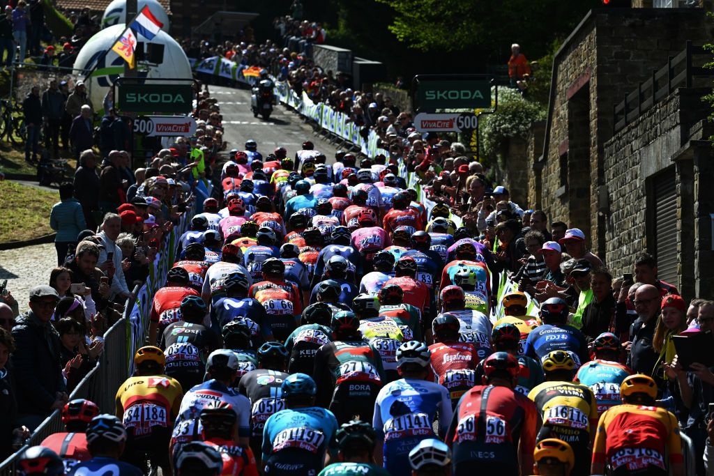 HUY BELGIUM APRIL 19 A general view of the peloton climbing to the Wall of Geraardsbergen Mur de Huy 204m while fans cheer during the 87th La Fleche Wallonne 2023 Mens Elite a 1943km one day race from Herve to Mur de Huy UCIWT on April 19 2023 in Huy Belgium Photo by Luc ClaessenGetty Images