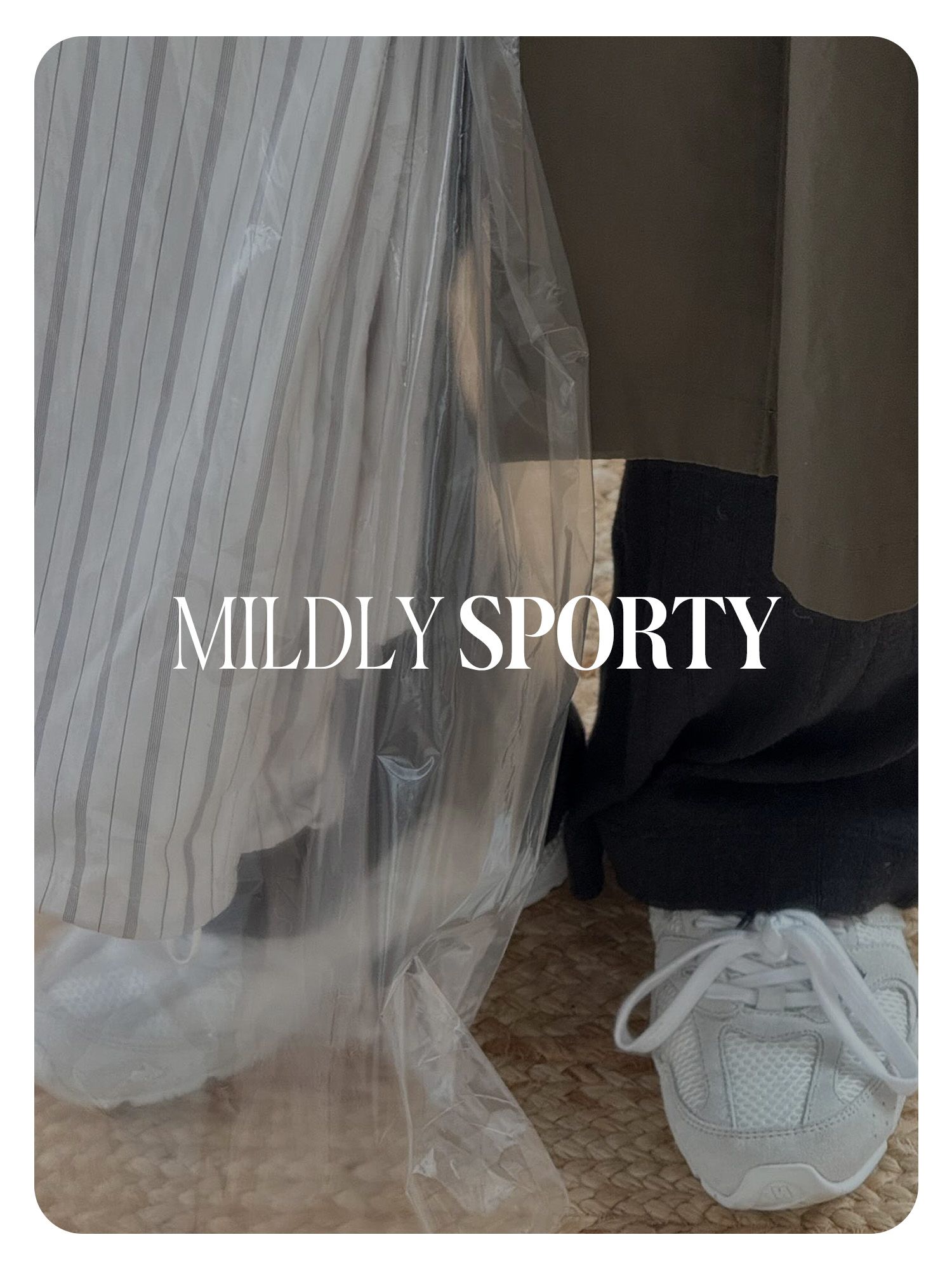 Monikh Dale's white minimalist sporty sneakers worn with black pants and a long trench coat. Text reads, "Mildly Sporty."