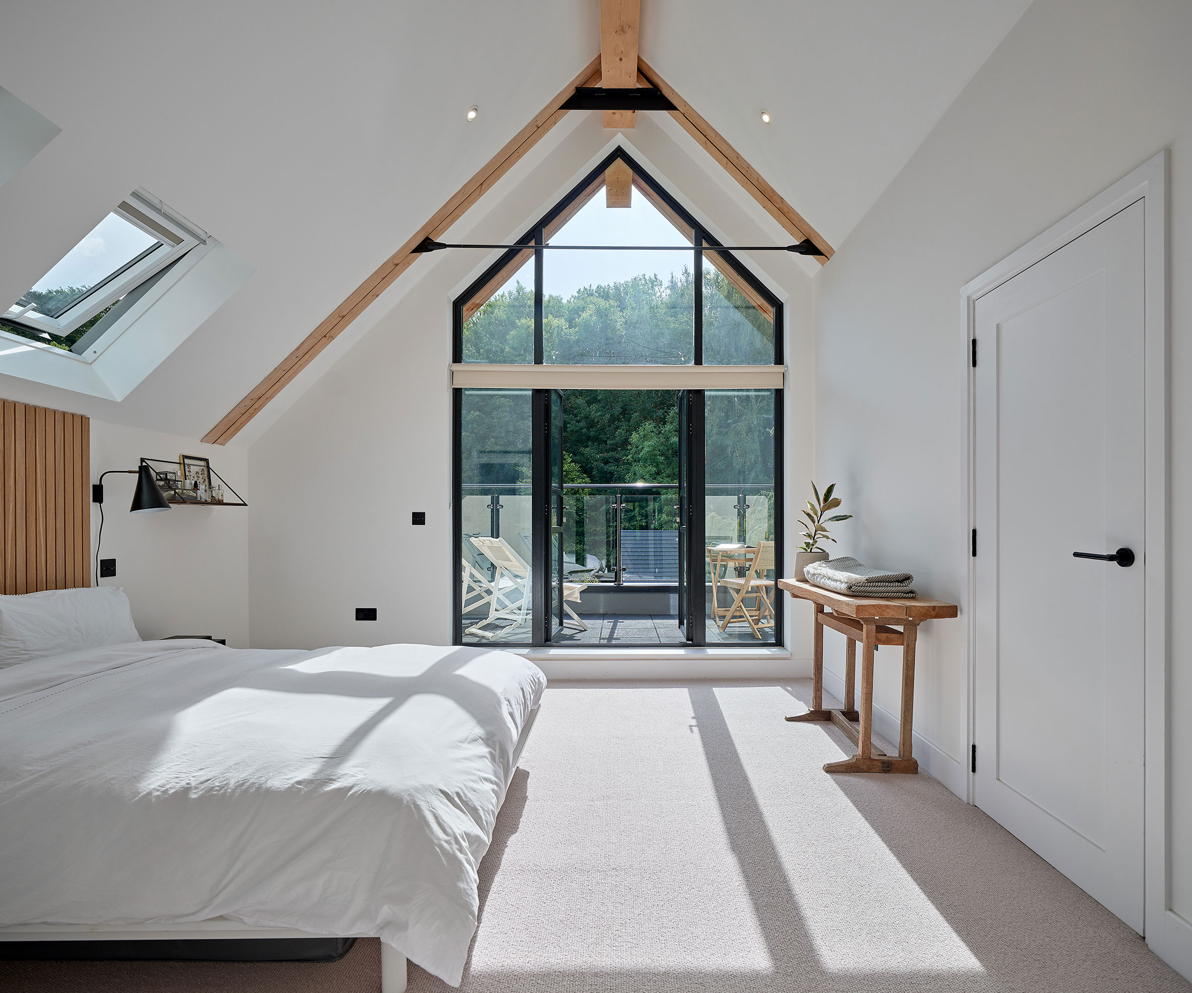 bedroom with vaulted ceiling and glazed gable and balcony