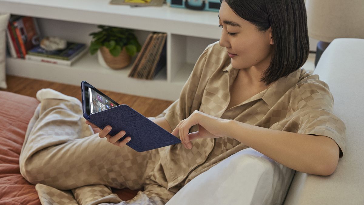 Amazon Fire HD 8 (2022) in-hand on couch promo