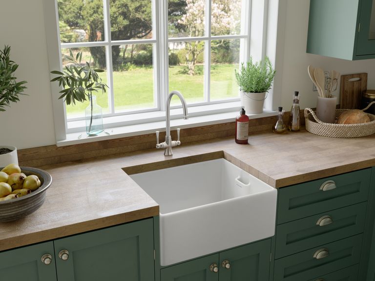 How to clean a kitchen sink – sink, wood countertops and green cabinets