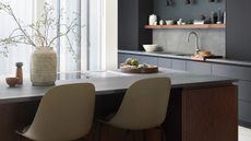 Sleek, modern dark kitchen with hob built into the kitchen island