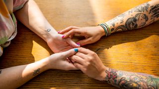 Tattooed couple holding hands