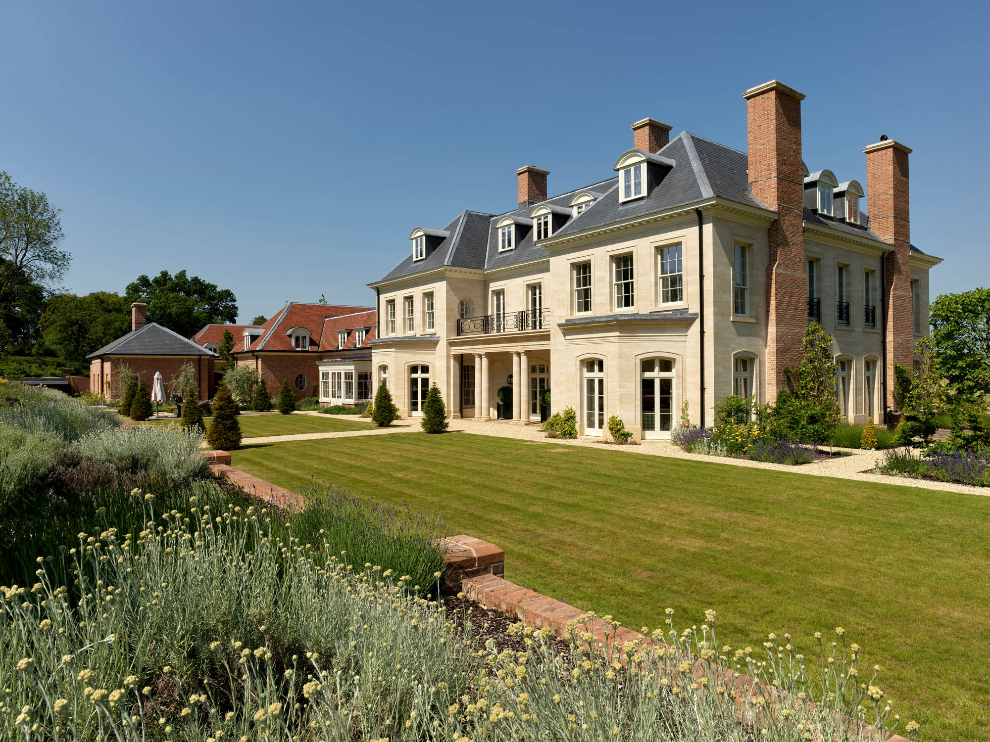 Fig 2: The south front of the house, facing the garden terrace and looking up to ancient woodland. The kitchen range lies to the left. Wield Park, Hampshire. Photograph: ©Paul Highnam for Country Life.