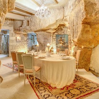 dining room with rug on floor and built in rock walls