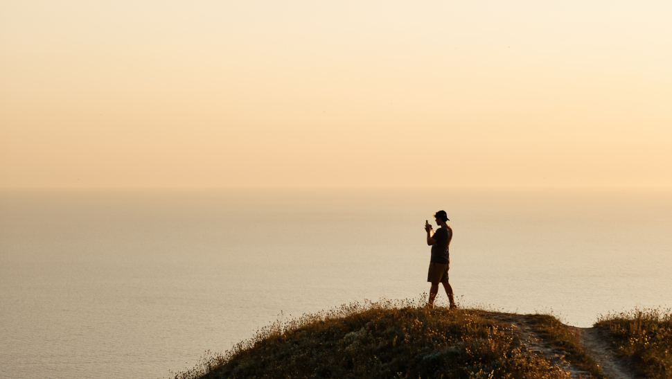 man taking picture with smartphone