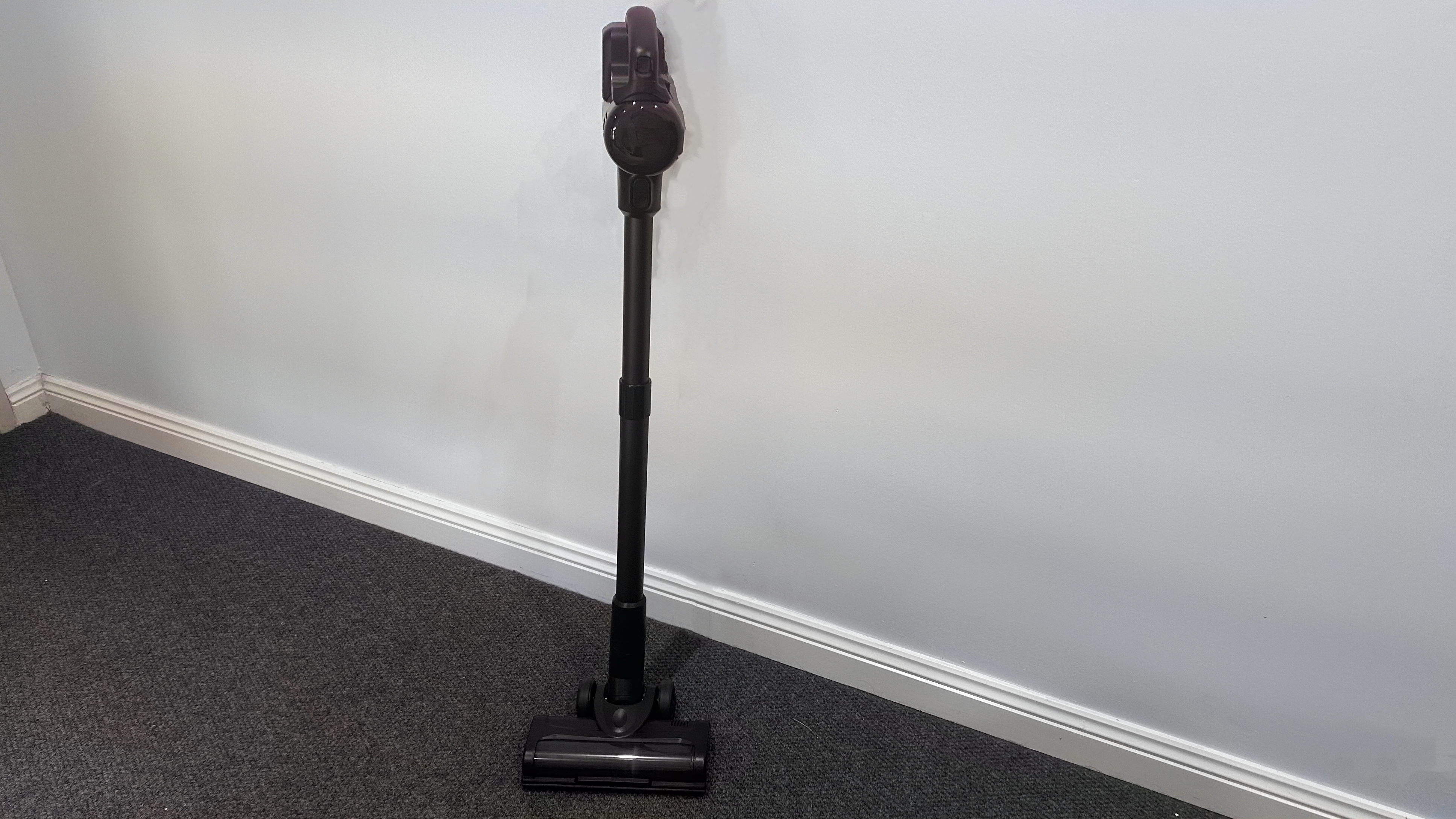 Eufy cordless vacuum on white wall