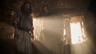 Rory Kinnear as “Tom Bombadil” (Left); Daniel Weyman as “The Stranger” (Right) standing side by side with the sun coming through the window behind them.