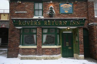 The Rovers Return in Coronation Street with snow and Christmas lights 