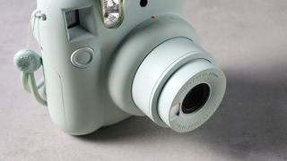 A mint green Fujifilm Instax mini 12 instant camera