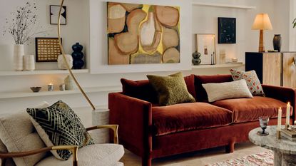 Soho Home orange velvet sofa in an art filled living room space