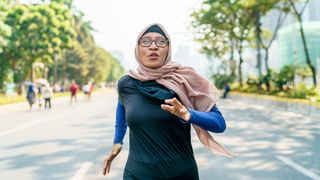 muslim woman running in a park