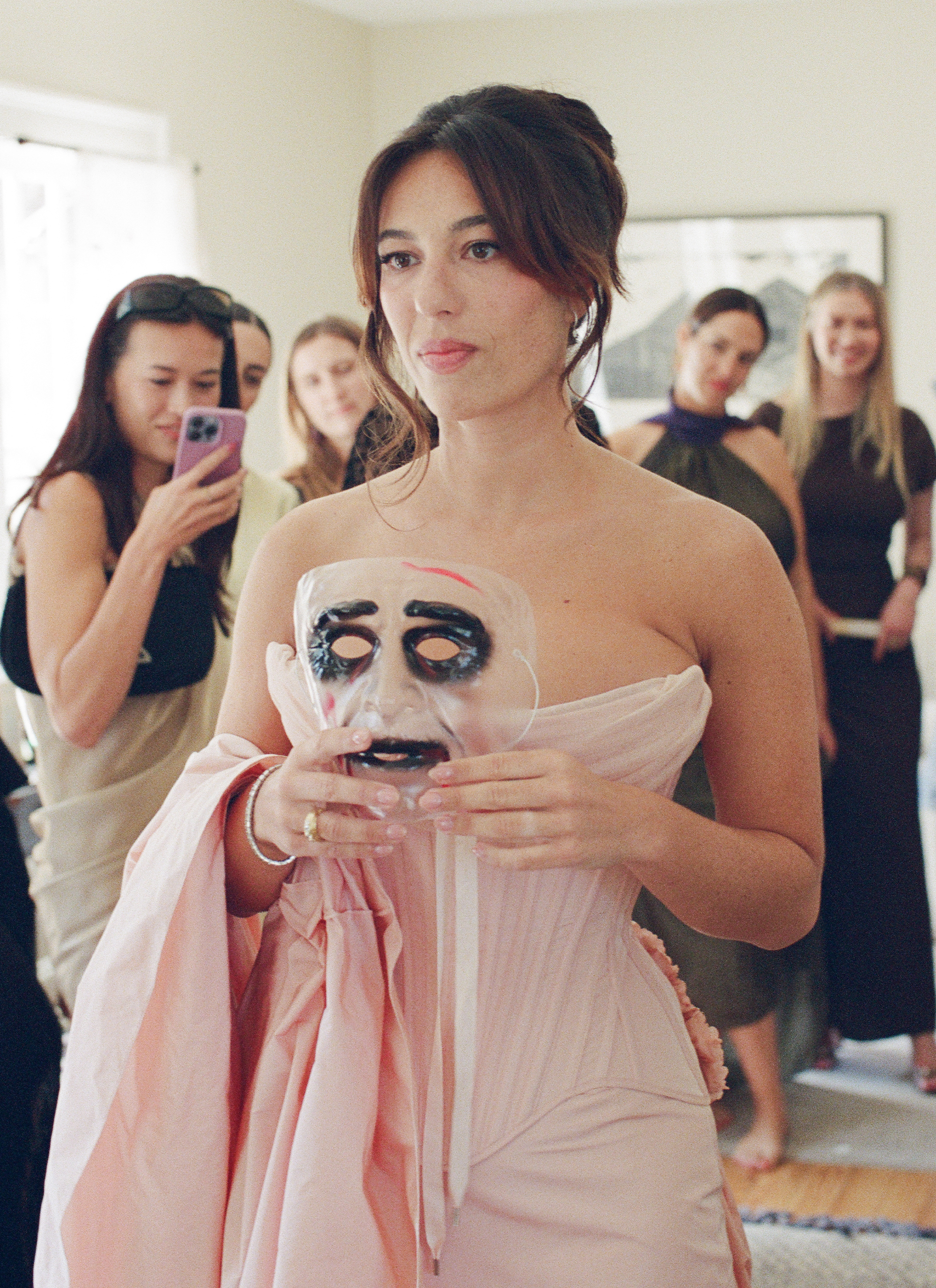 Hadley looking in the mirror with a mask.