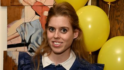Princess Beatrice's layered look as she poses with Jarvis's winning book 'The Boy With Flowers in His Hair' 