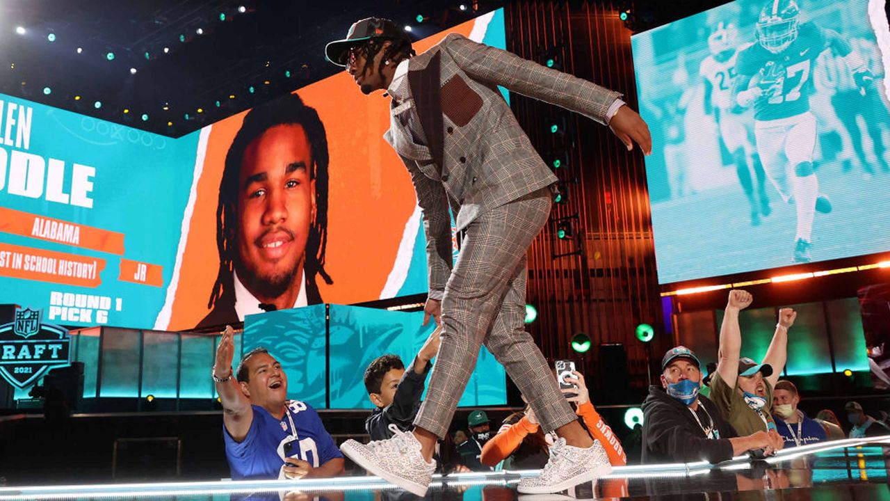 Jaylen Waddle walks onstage after being selected with the sixth pick by the Miami Dolphins during round one of the 2021 NFL Draft on April 29, 2021 in Cleveland,.