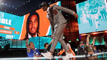 Jaylen Waddle walks onstage after being selected with the sixth pick by the Miami Dolphins during round one of the 2021 NFL Draft on April 29, 2021 in Cleveland,.