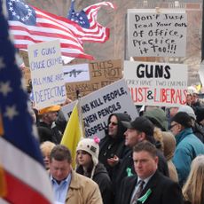 Gun rights proponents hold signs at a rally
