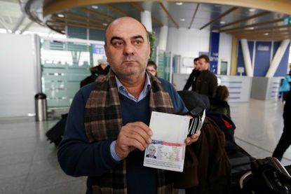 Fuad Sharef Suleman shows his U.S. visa after returning to Iraq from Egypt, where he was prevented from boarding a plane to the U.S. on Jan. 29, 2017.
