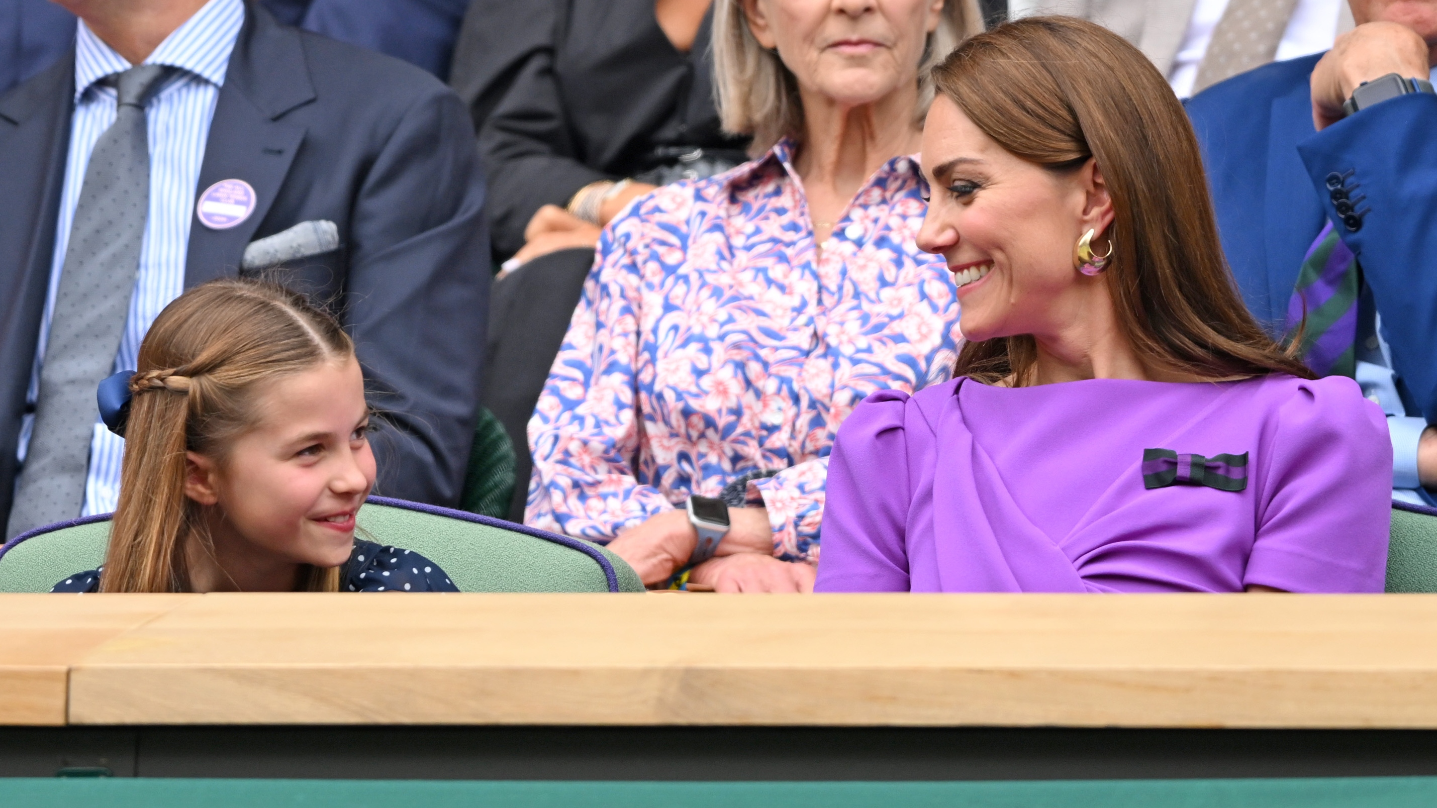Princess Charlotte of Wales and Catherine, Princess of Wales smiling at each other during the Wimbledon men's final on July 14, 2024