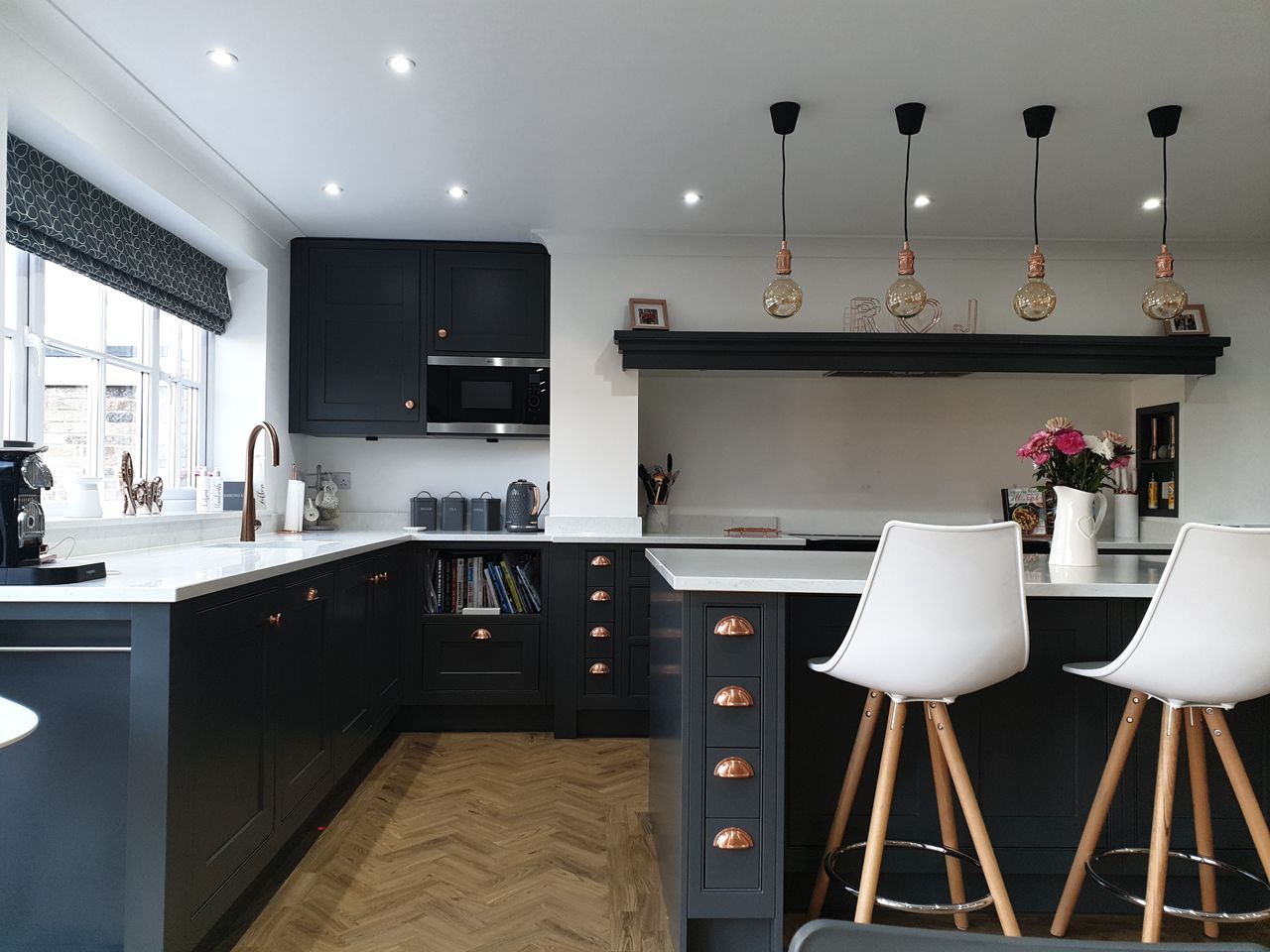 A blue and white toned kitchen with a quartz countertop