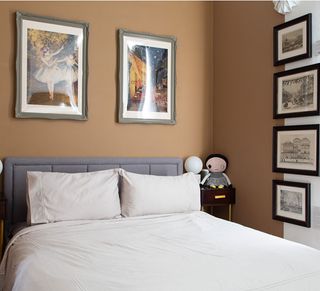brown bedroom with grey bed and white bedding