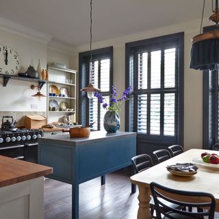 kitchen with blue shutter frame windows and blue cabinets