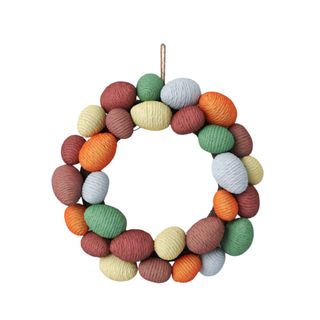 A multicolored egg wreath with woven eggs in pale yellow, brown, orange, blue and green shades