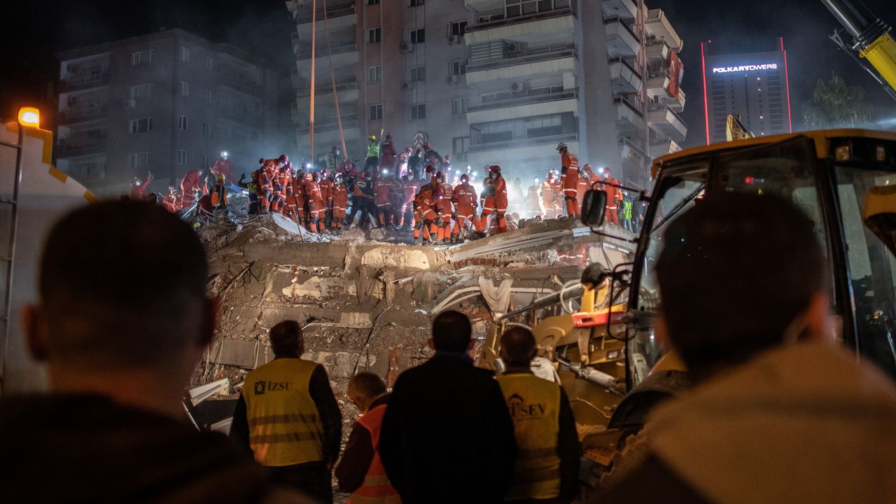 Emergency services personnel search a collapsed after a powerful earthquake struck Turkey.