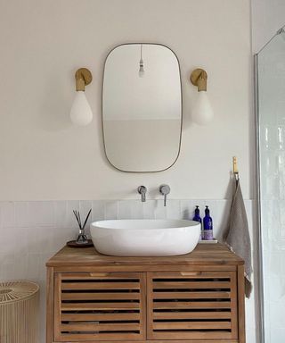 Bathroom with wooden vanity and mirror