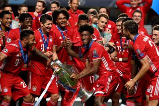 Bayern Munich players celebrate with the Champions League trophy after winning the 2020 final against PSG