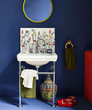 Cobalt blue bathroom with floral sink tiles and bright colour accents