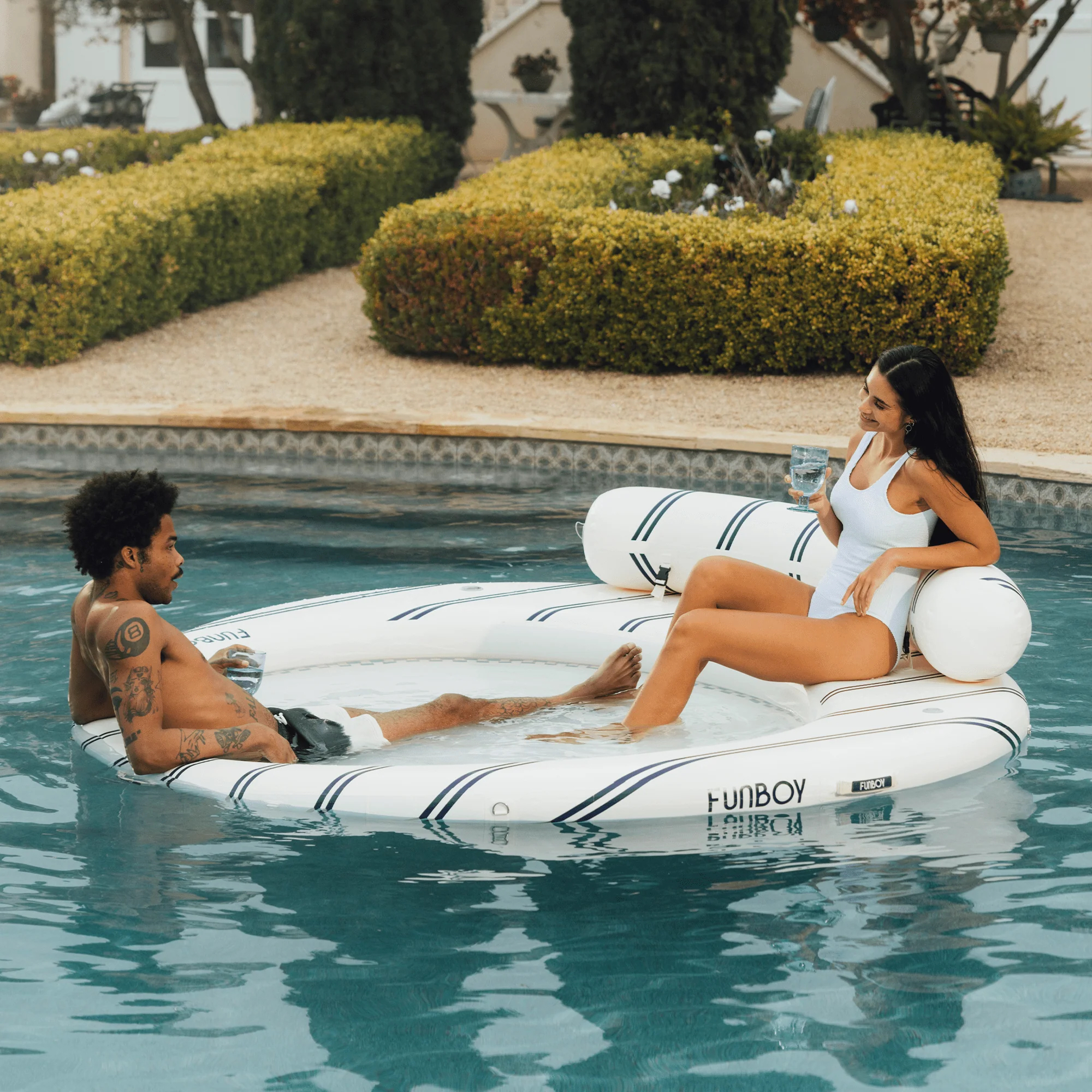 A man and a woman sit on the Funboy Leisure Island float