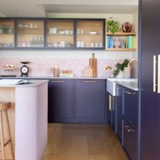 Purple kitchen with pink island and backsplash