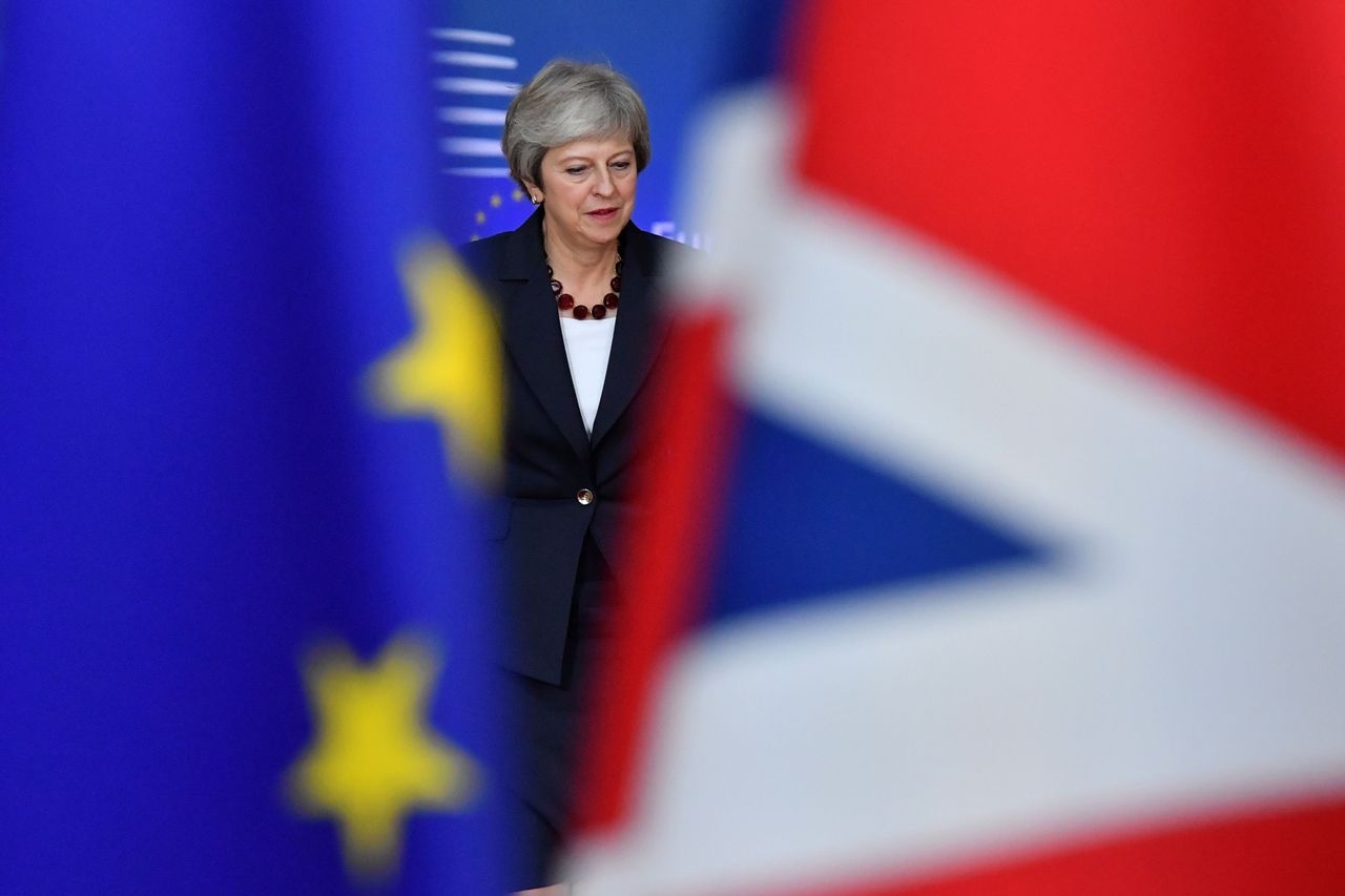 Theresa May between two flags