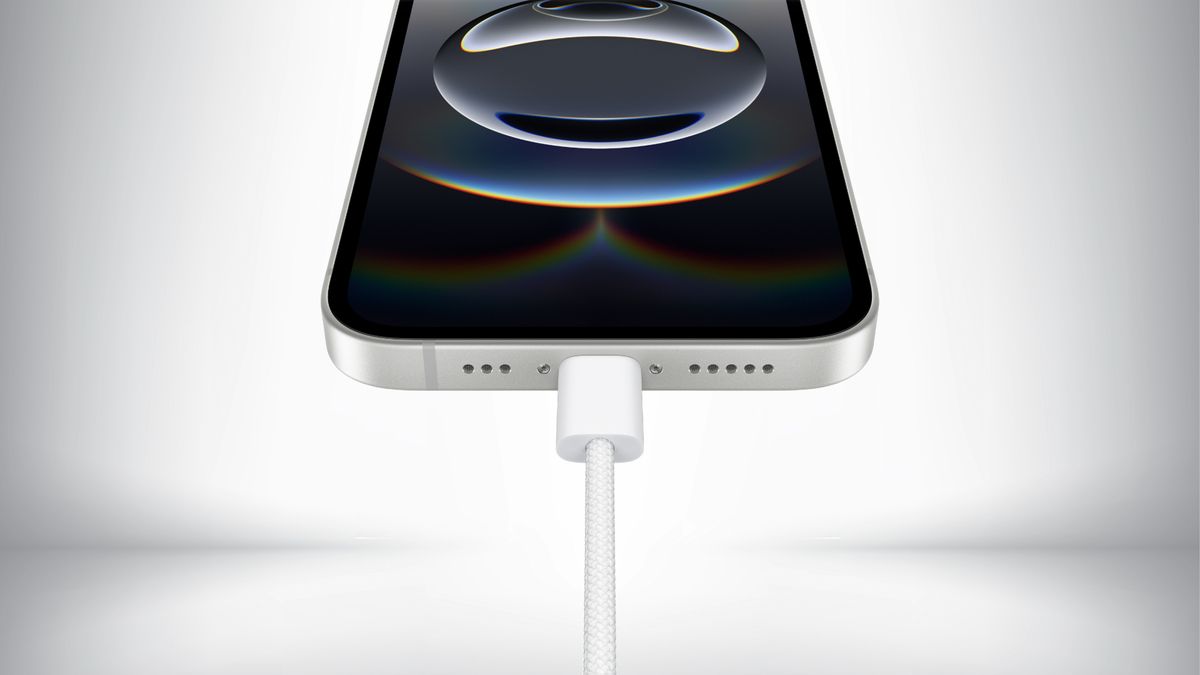 Close up of the USB Type-C charging port on the iPhone 16e in front of a gray background