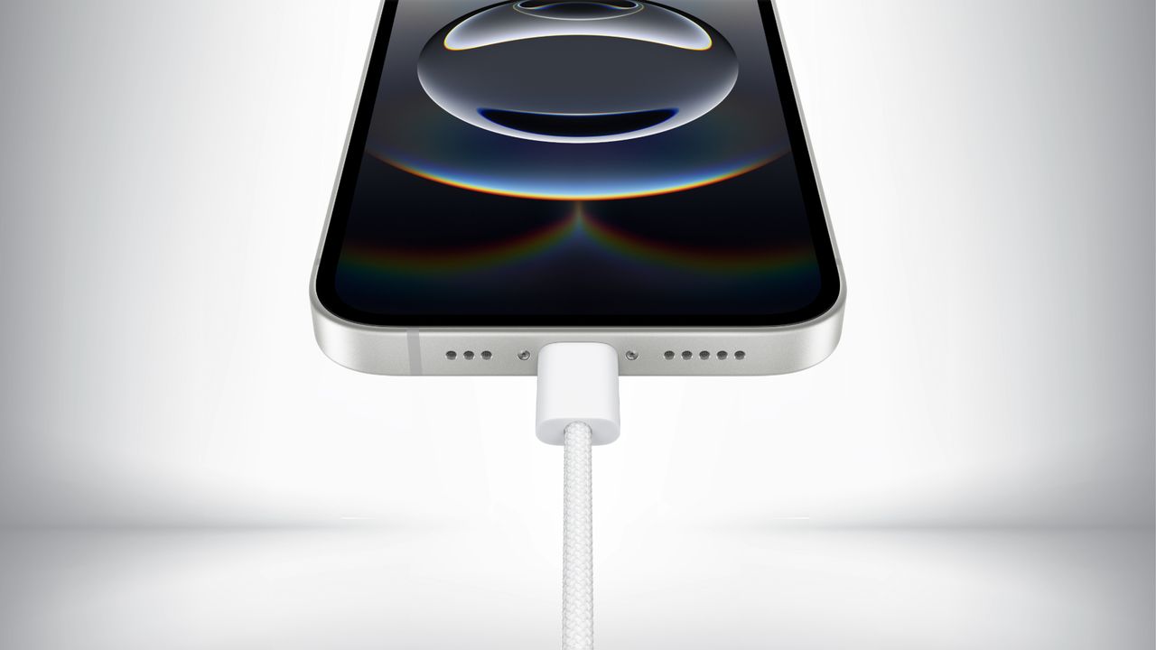 Close up of the USB Type-C charging port on the iPhone 16e in front of a gray background