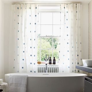 bathroom with white window and white curtain