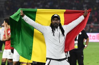 Aliou Cisse celebrates with the Senegal flag after winning the Africa Cup of Nations in 2022.