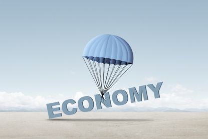 soft landing concept shown word economy tied to a parachute slowly falling to the ground