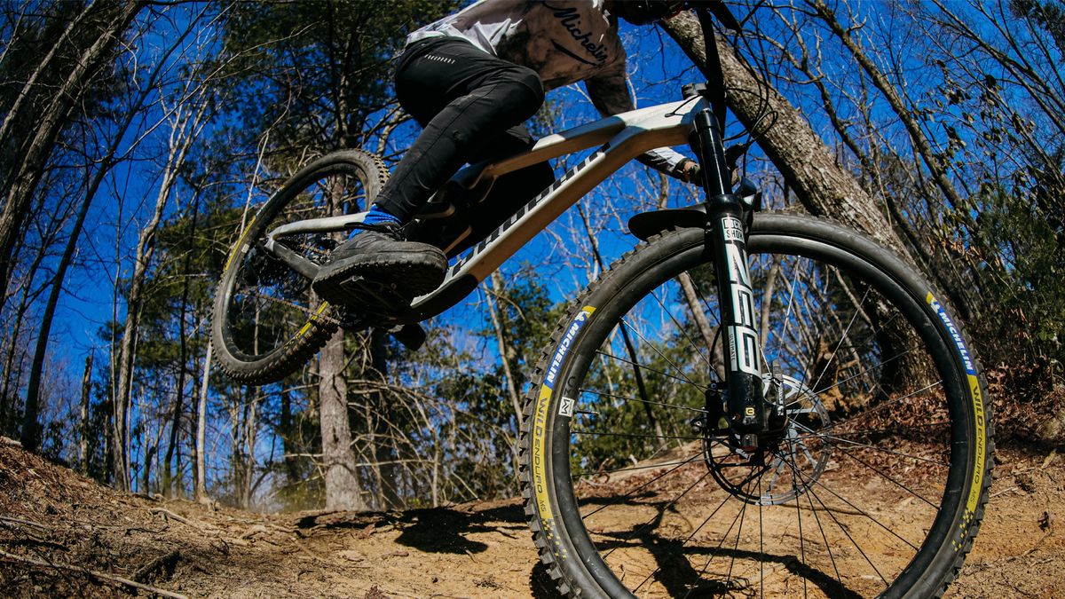 A man riding a Propain MTB with Michelin tires