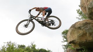  Thomas Pidcock of Team Great Britain jumps off a boulder ahead of the Mountain Bike World Championships 2024 live stream