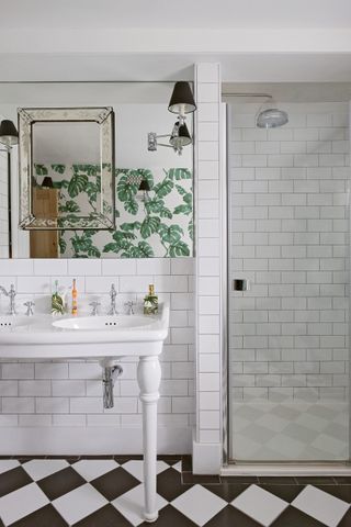 All white bathroom with black and white checkerboard floor tiles