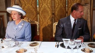 Queen Elizabeth and Prince Philip at a formal luncheon in Paris during an official visit