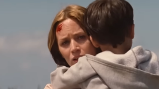 Emily Blunt carries her son through a cornfield in Looper.