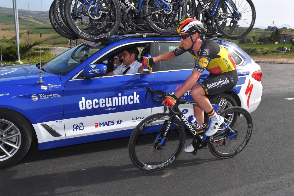 Yves Lampaert (Deceuninck-Quick Step) takes a snack from the team car