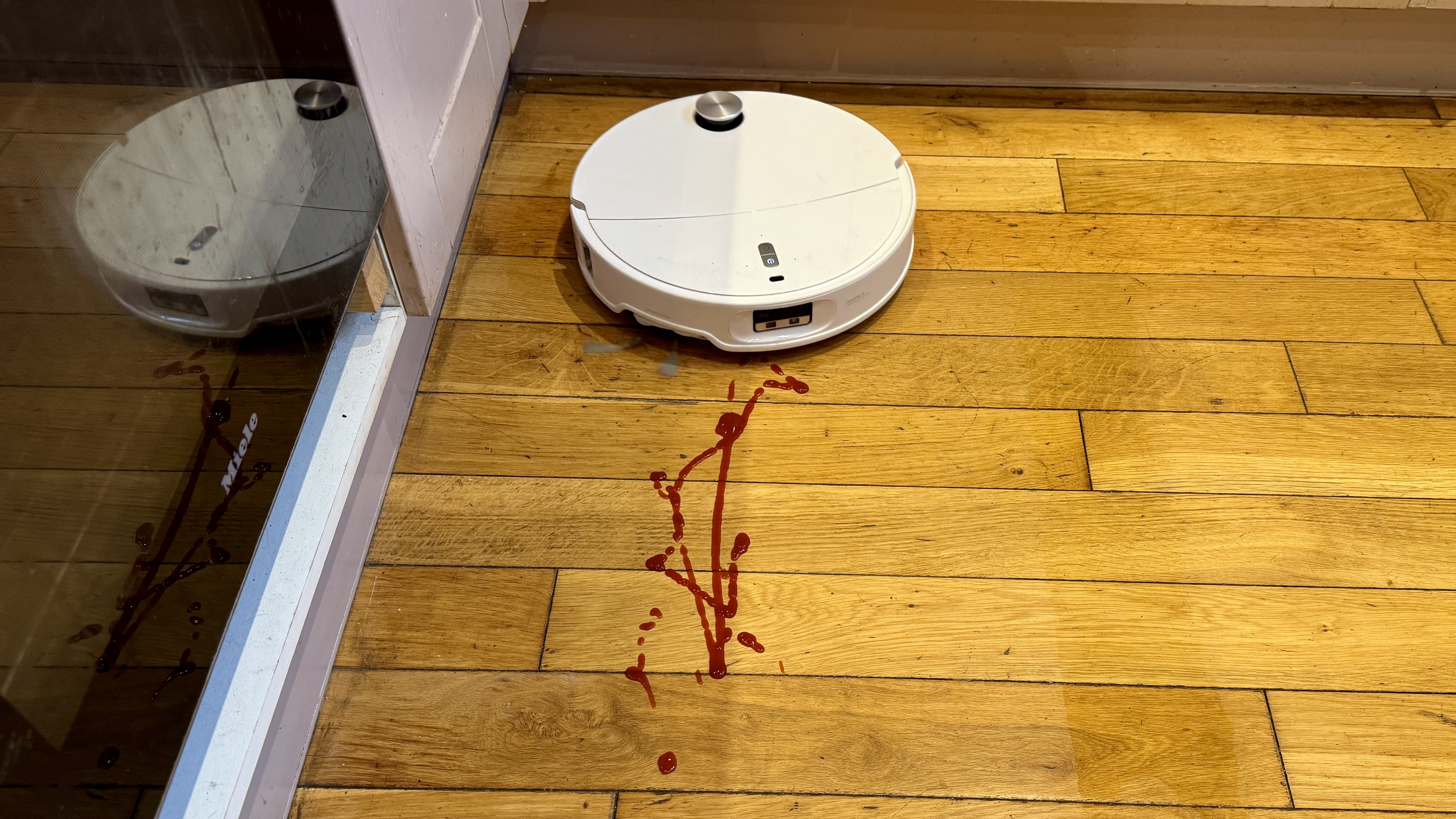 Roborock Qrevo Curv 2 Pro cleaning a spillage from a hard floor