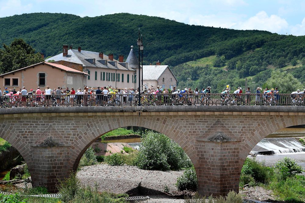 The peloton crosses a bridge during stage 15 at the Tour de France