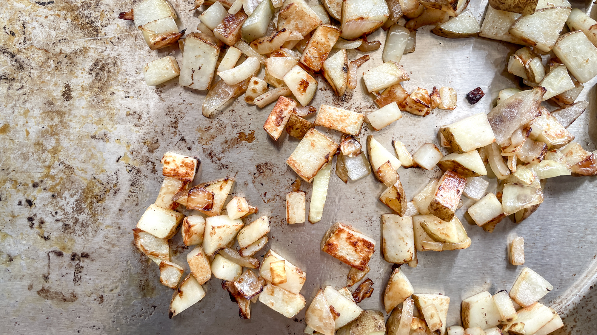 Cooking potato and onion on a Solo Stove Steelfire 22 Griddle