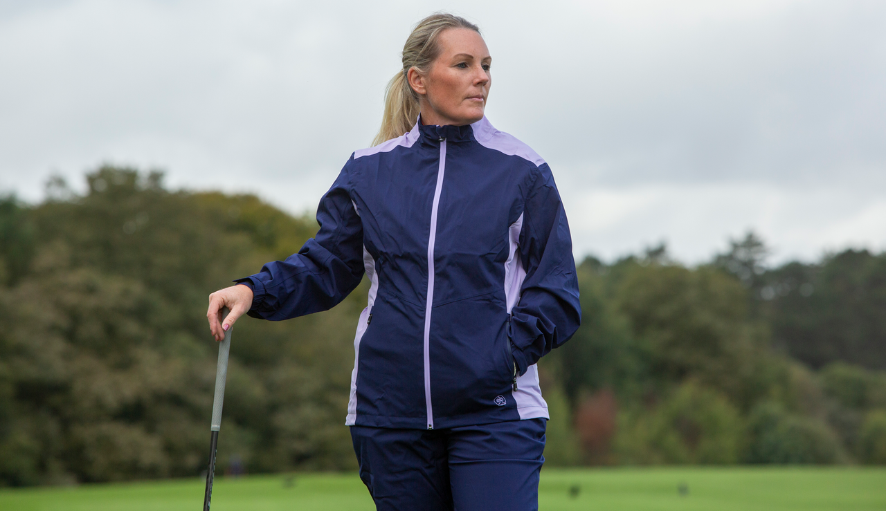 A golfer wears the Proquip Darcey Ladies Rain Jacket